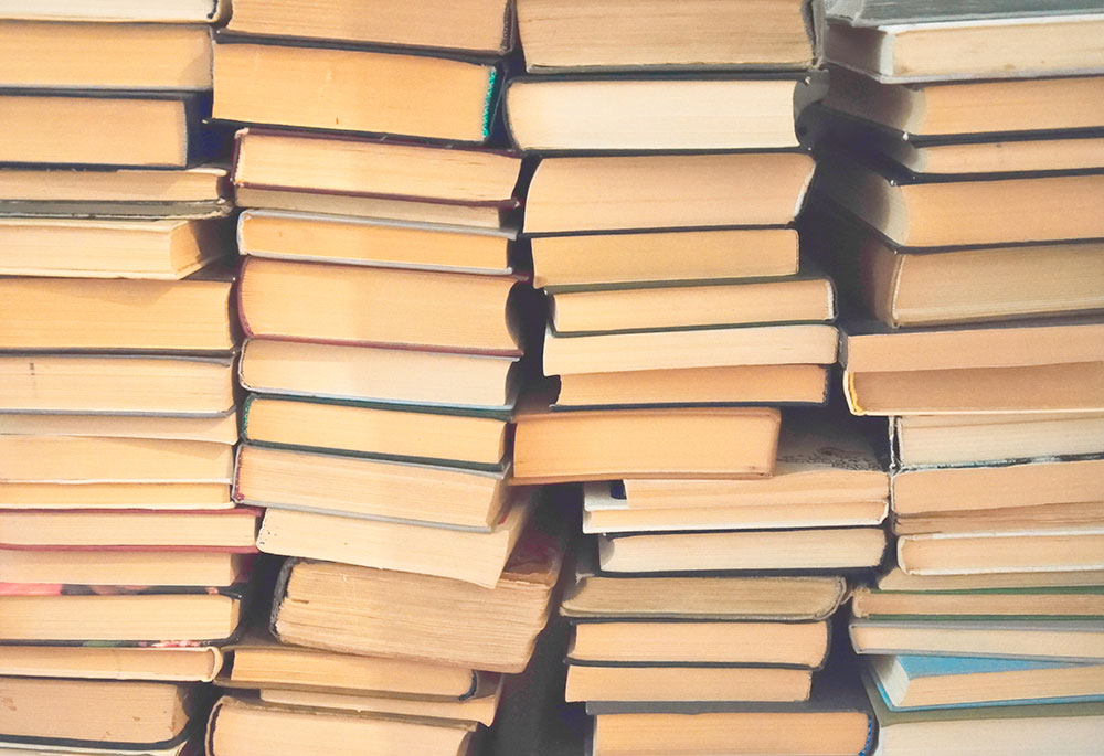 Photo of a wall of books with their pages facing out