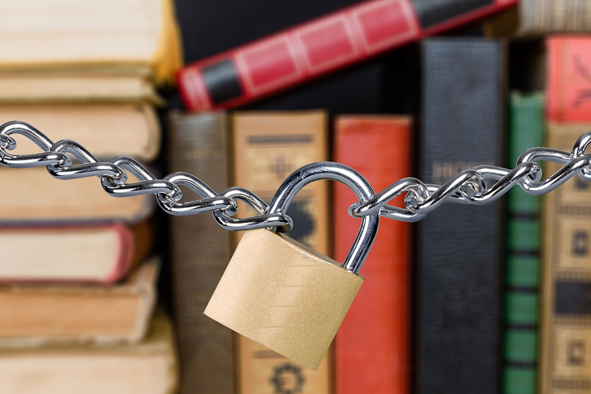 Photo of padlock and chain in front of books