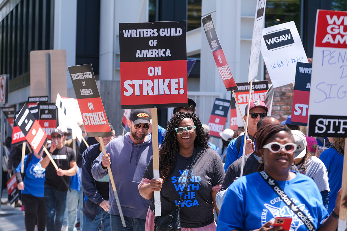 Members of the Writers Guild of America walk with pickets on strike outside the Culver Studio in Culver City, California.