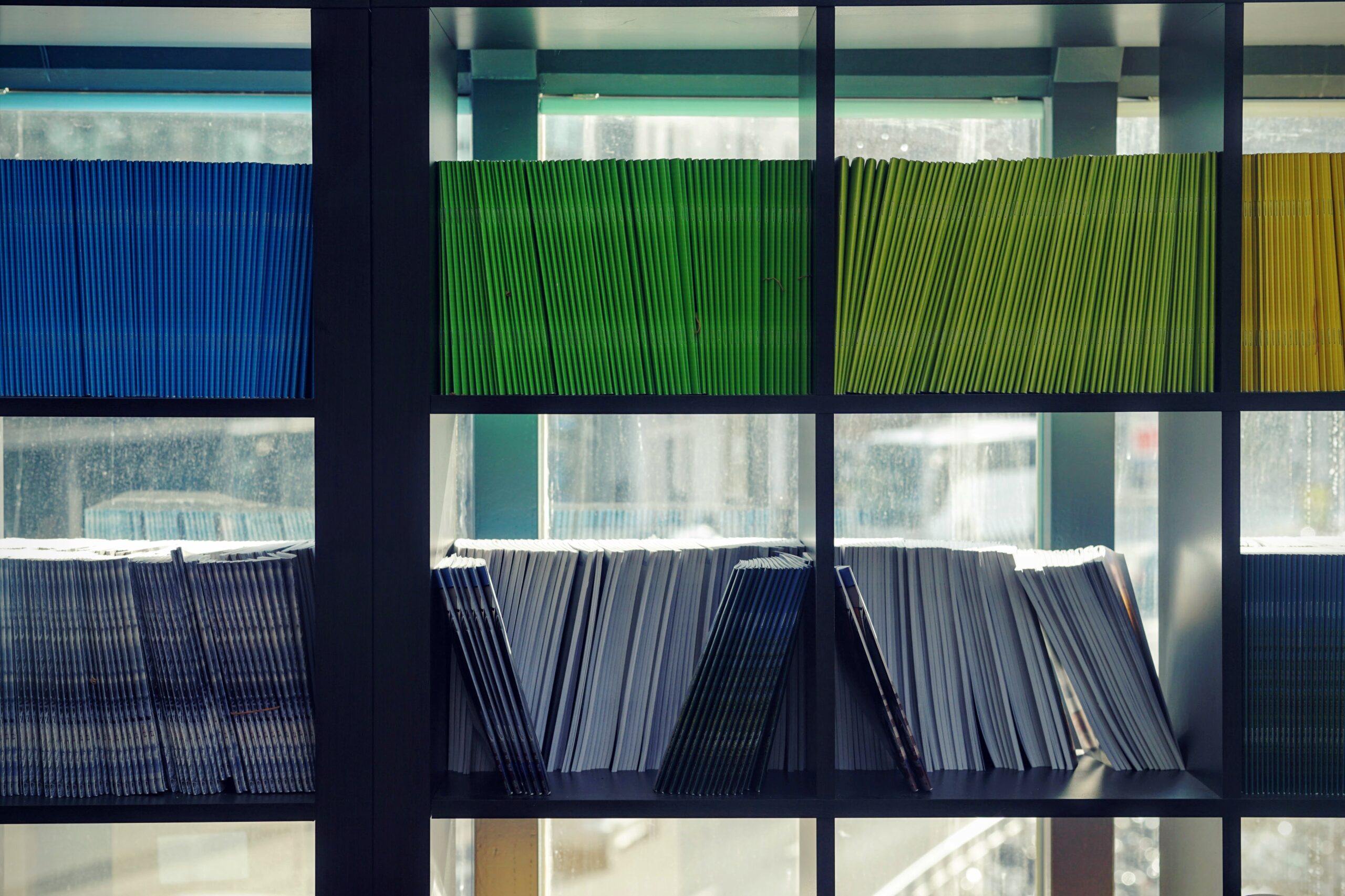 Multicolored files on a bookshelf