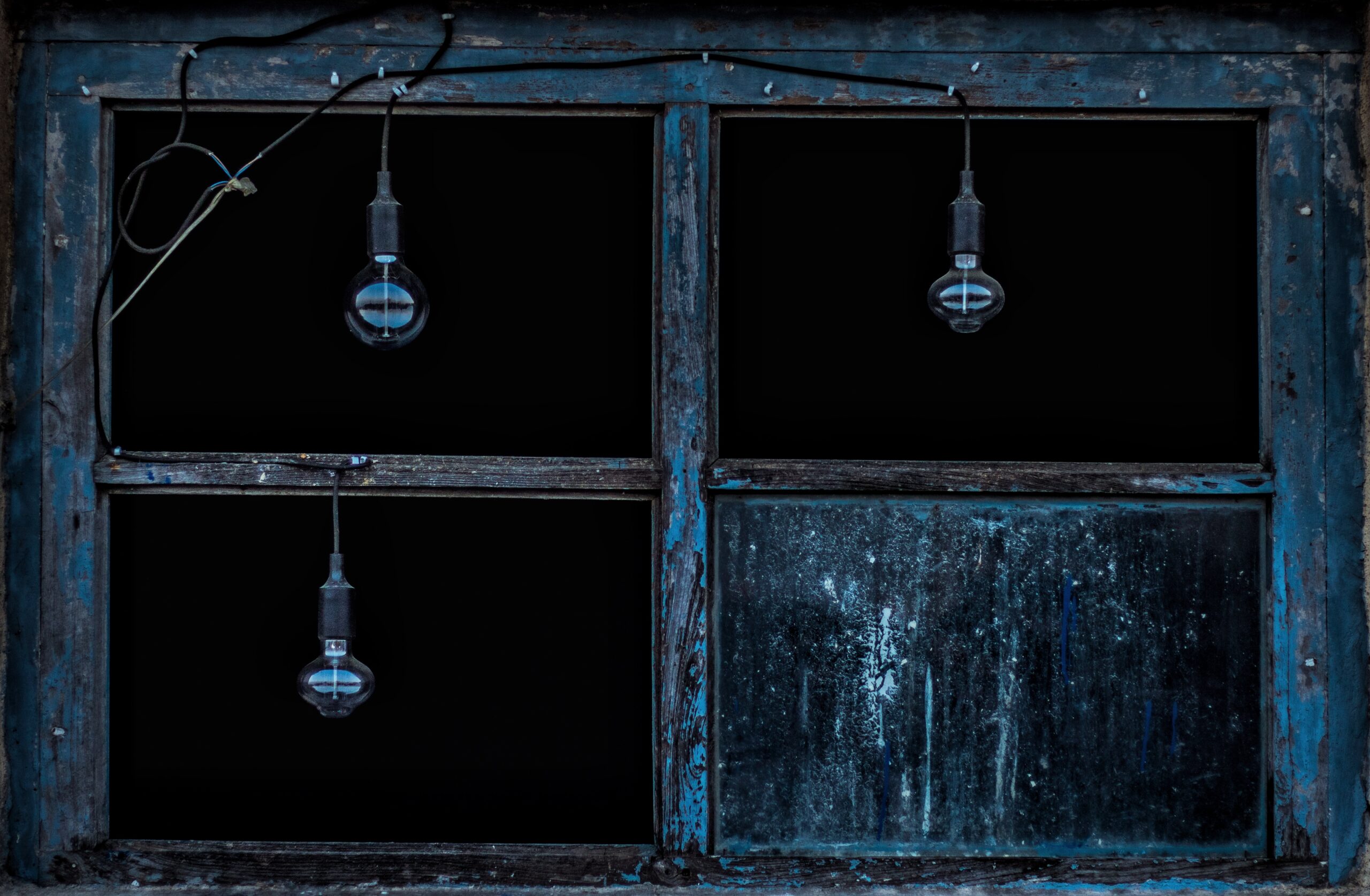 Illustration of blue window frame with dark lamps hanging down