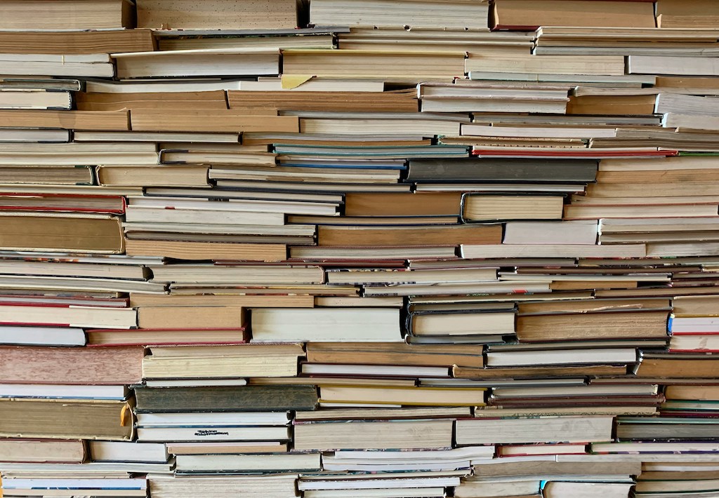 Pile of books stacked on top of one another.