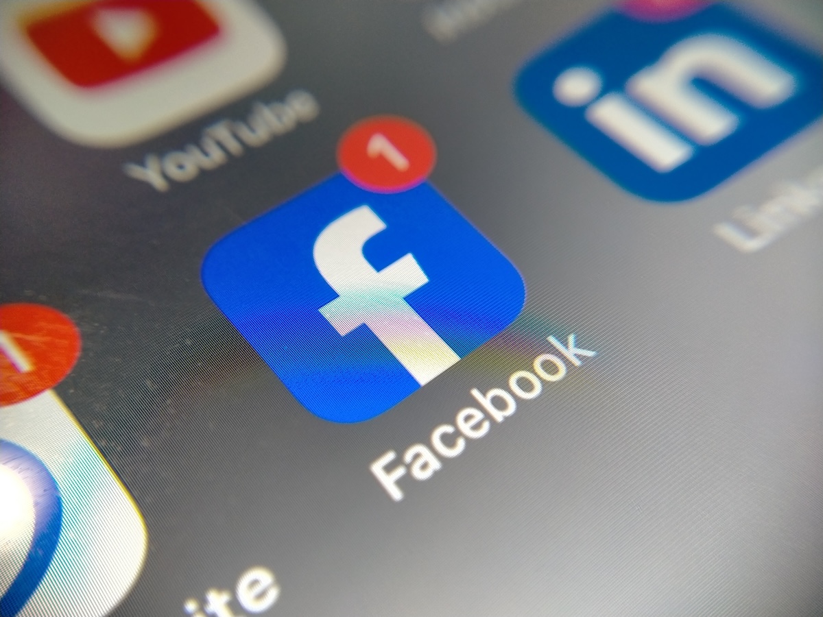 Closeup of a blue Facebook app icon on a smartphone screen